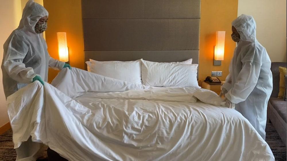 The Waterfront Hotel Kuching Exterior foto Housekeeping staff making a bed